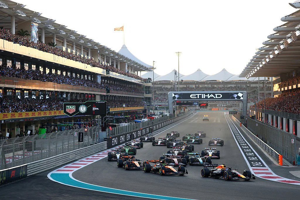 The opening lap of a Formula 1 race at Yas Marina Circuit, Abu Dhabi, the field streaming down the main straight