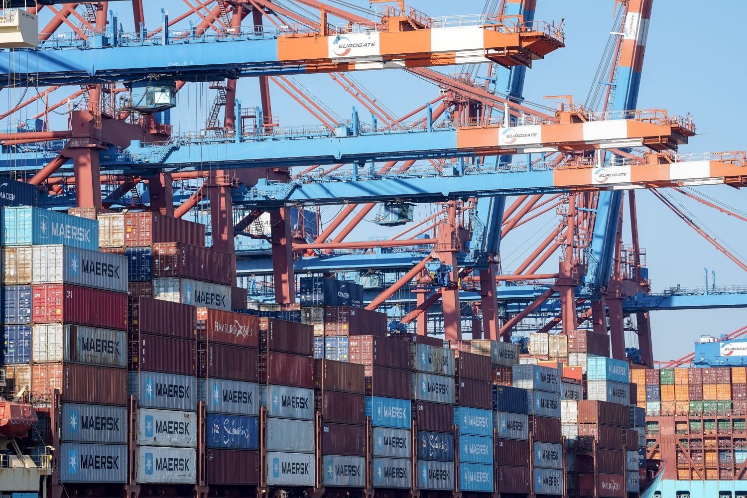 Ship-to-shore cranes working a container vessel at a port terminal